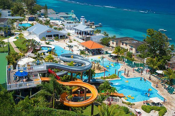 An aerial view of a water park with a swimming pool and a water slide.