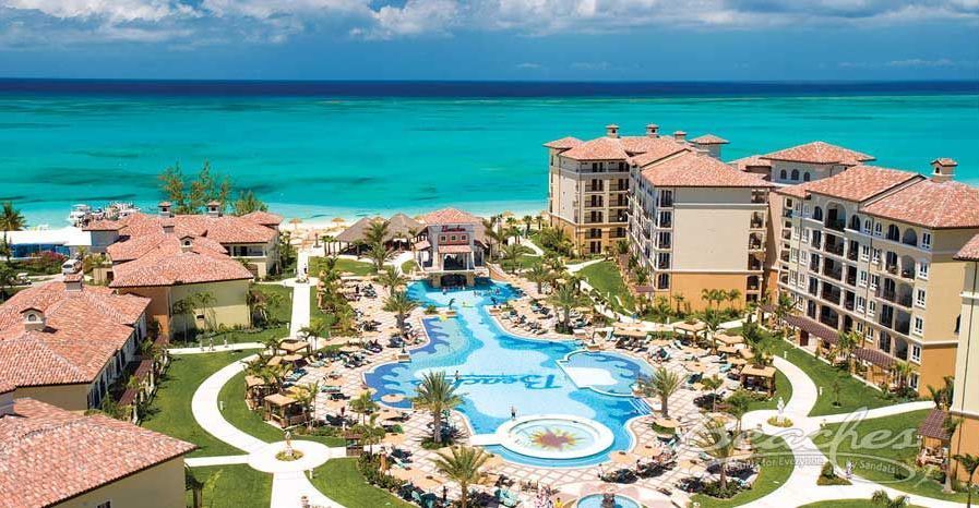 An aerial view of a resort with a large pool in the middle of it.