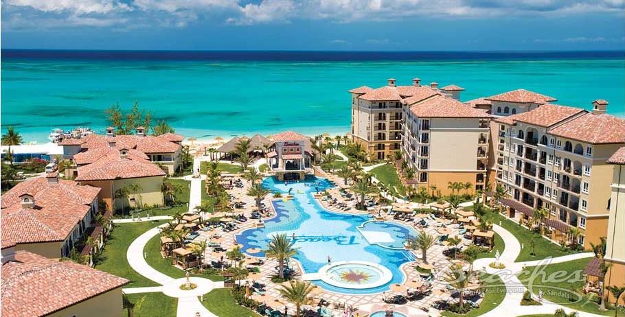 An aerial view of a resort with a large pool in the middle of it.