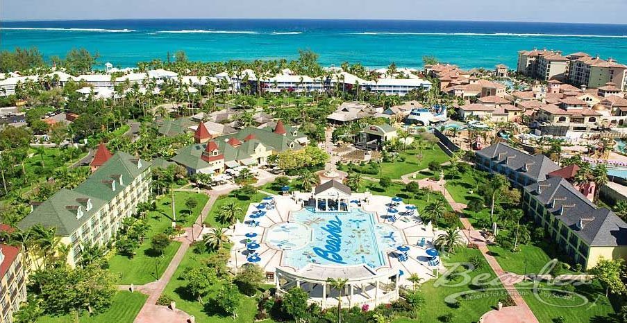 An aerial view of a resort with a large swimming pool