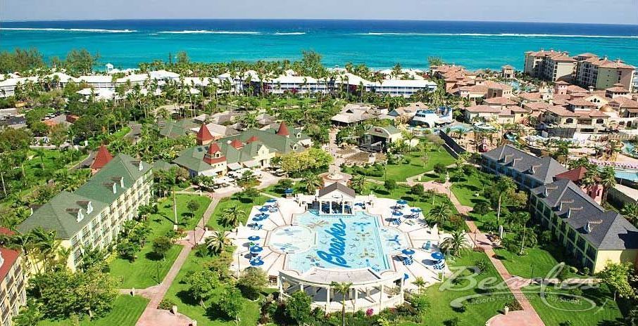 An aerial view of a resort with a large swimming pool