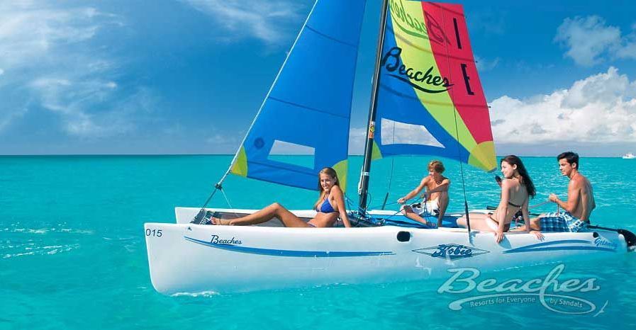 A group of people are on a sailboat in the ocean.