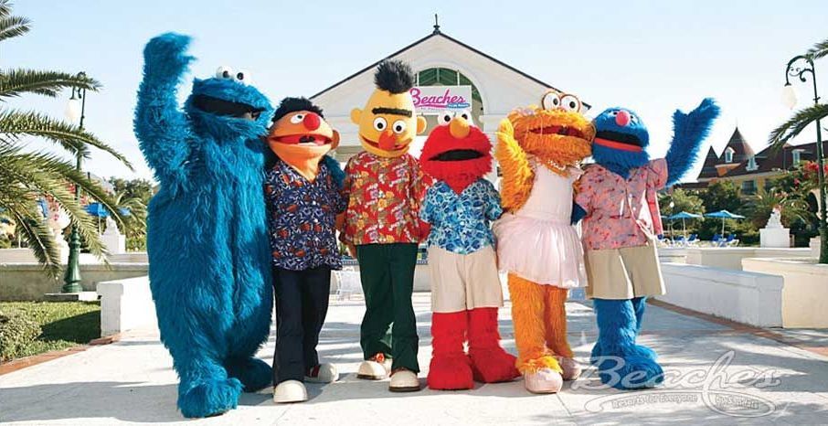 Several sesame street characters are posing for a picture