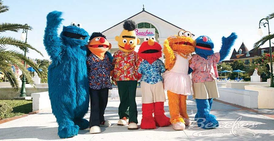 Several sesame street characters are posing for a picture