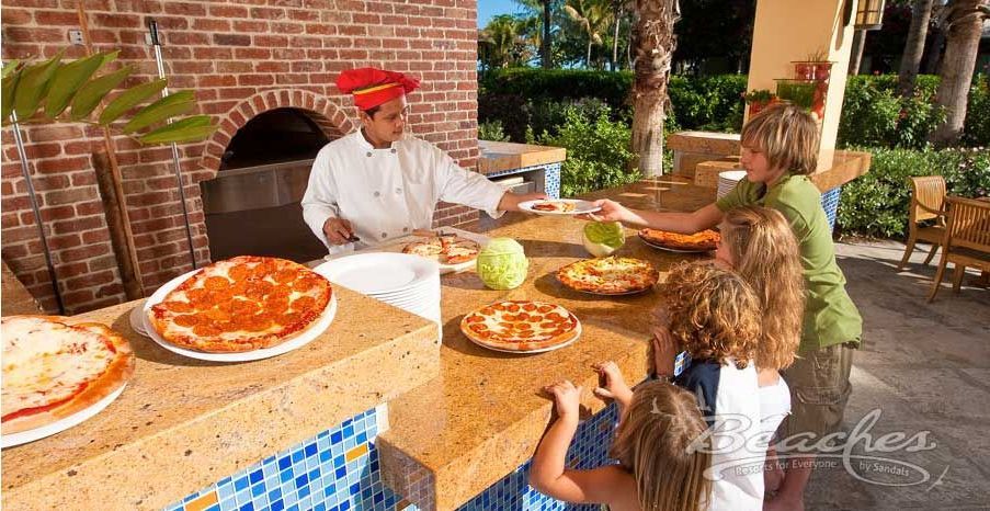 A group of people are sitting at a table eating pizza.