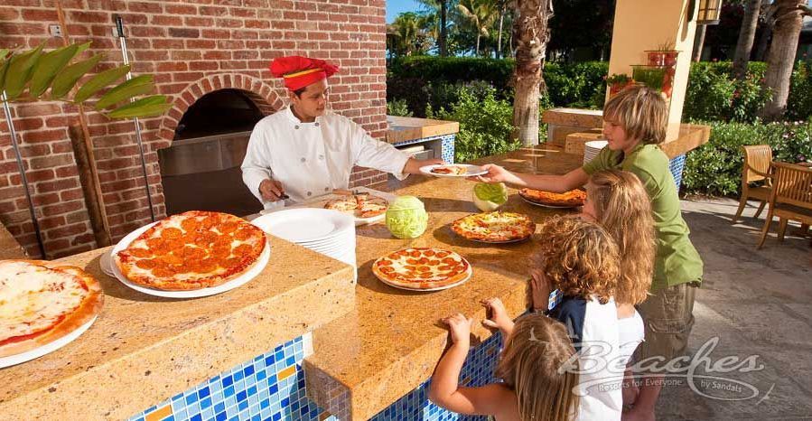 A group of people are sitting at a table eating pizza.
