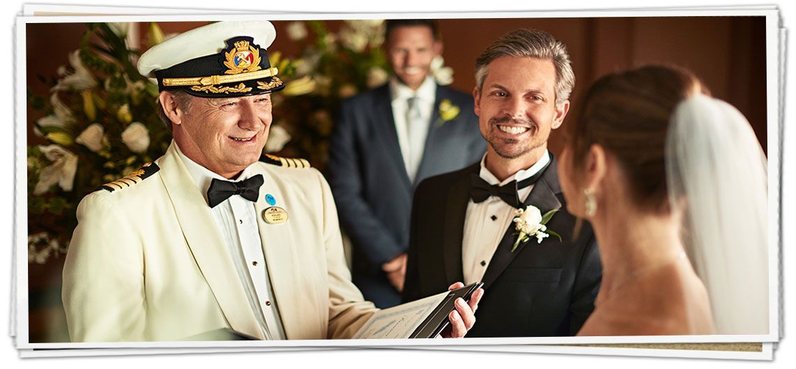A man in a suit is giving a bride and groom a wedding ceremony.