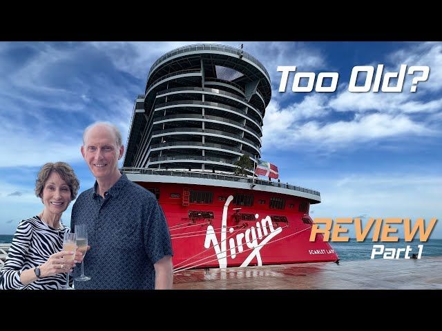 A man and woman standing in front of a virgin cruise ship