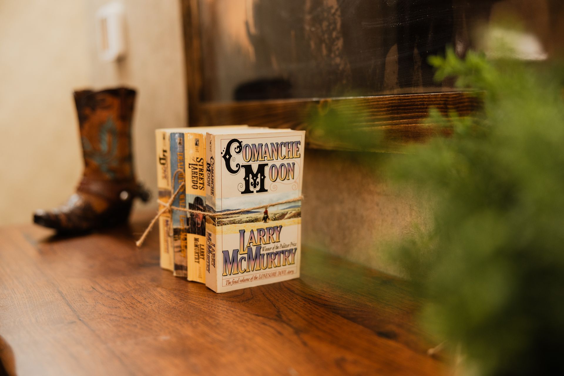 Two boxes of soap are stacked on top of each other on a wooden table.