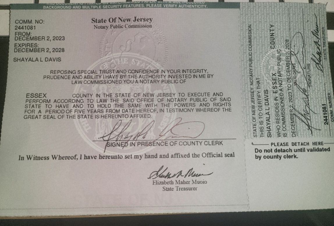 A piece of paper with a signature on it is sitting on a desk.