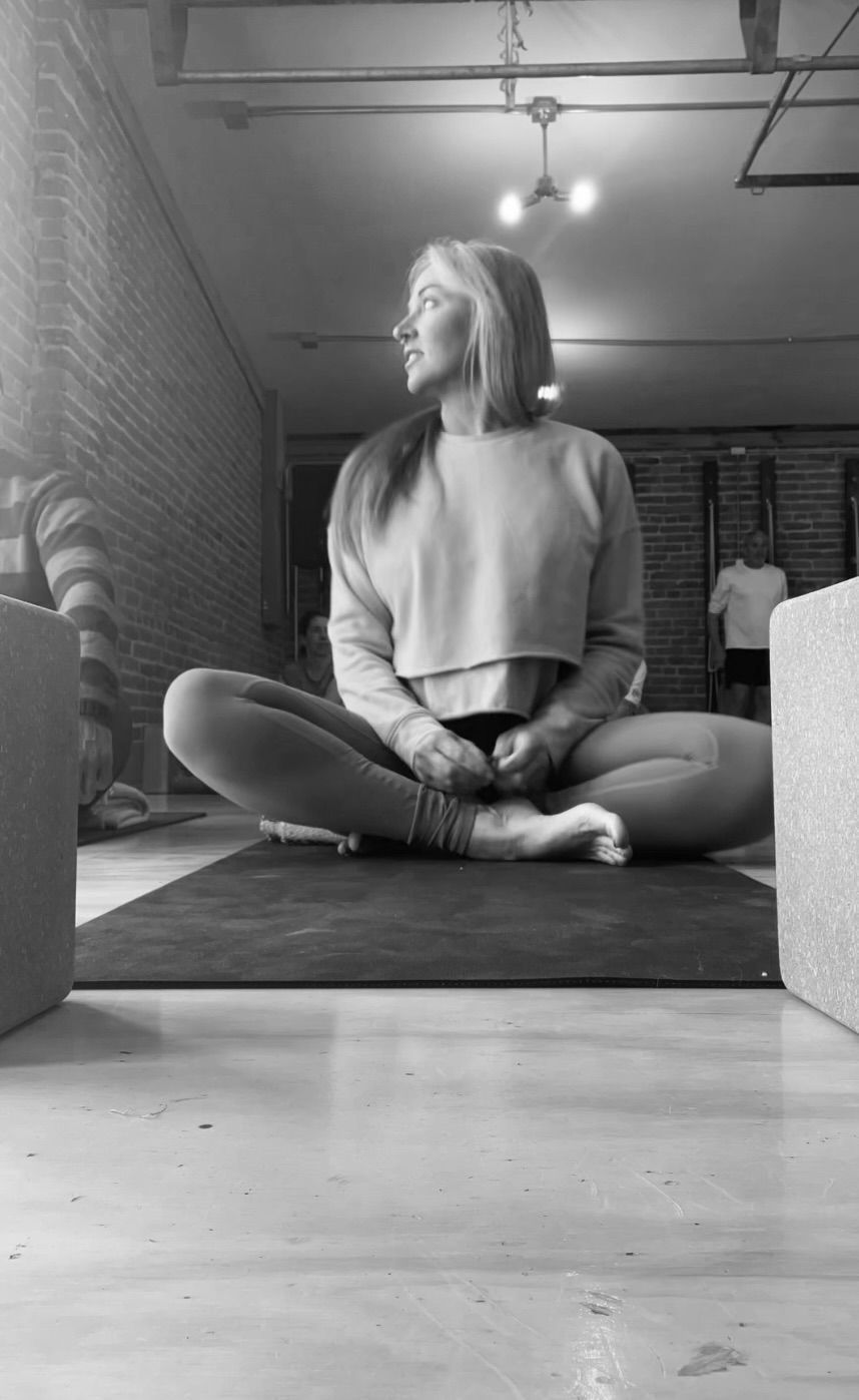 Desirae taking a yoga class.