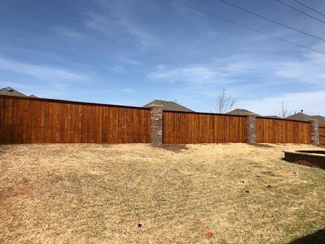 Wooden Fence - Stained Fence with Stone Columns in Oklahoma City, OK