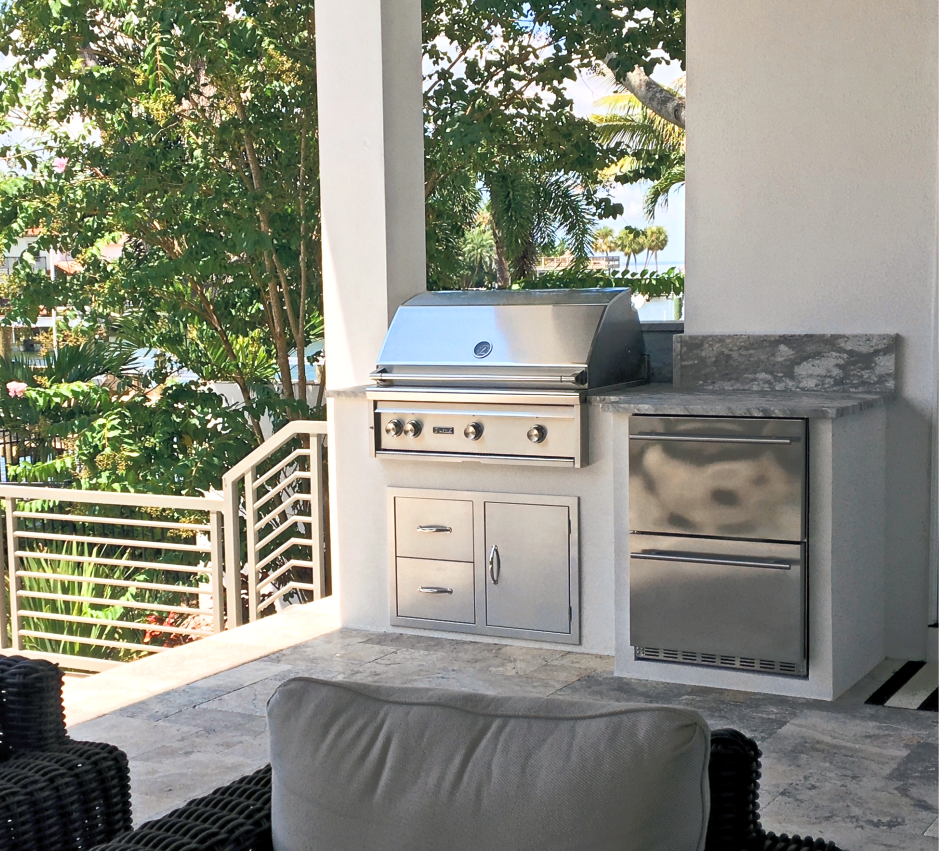 There is a fire pit on the patio with chairs around it.