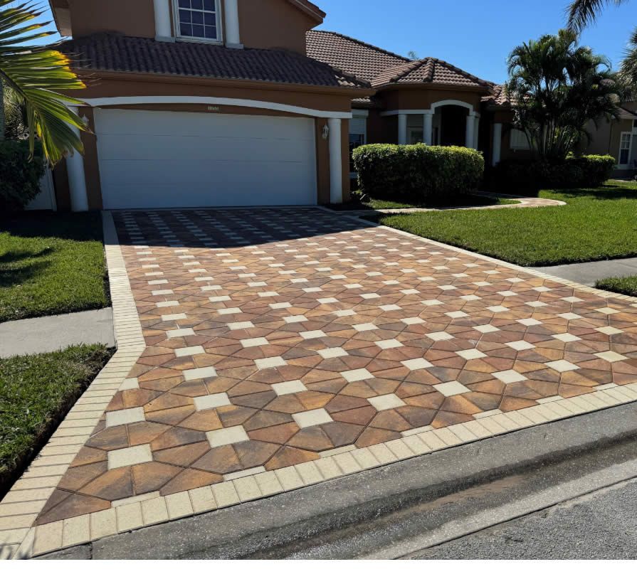 A brick paver driveway leading to a white house in sebastian florida.