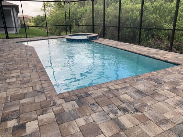 A statue of a turtle is sitting on a brick patio.