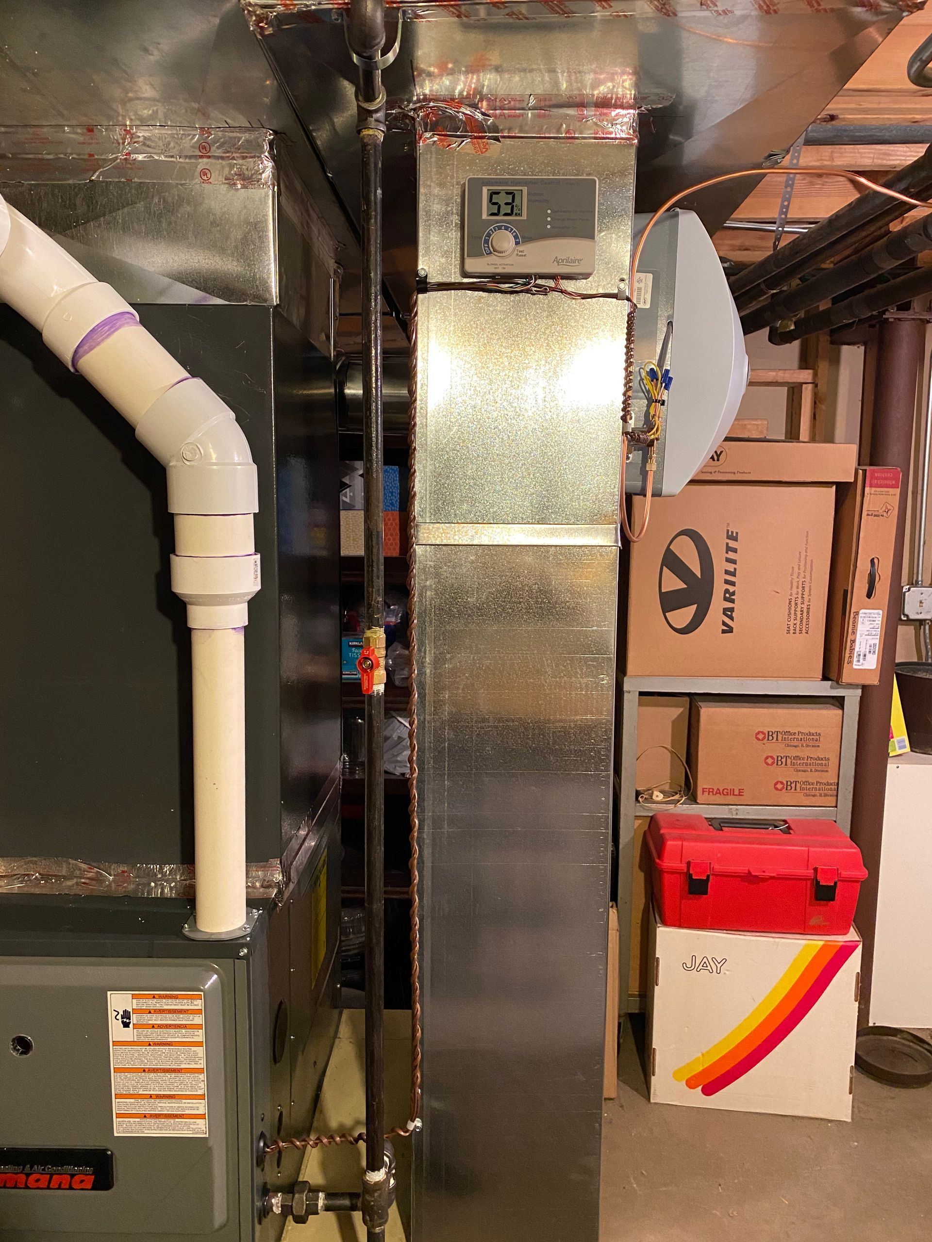 Furnace and ductwork in a basement setting; digital thermostat reads 53 degrees.