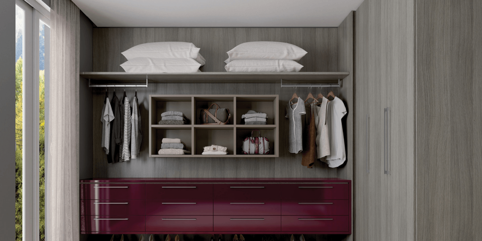 Un vestidor con cómoda, cajones, estantes y ropa colgada en la pared.