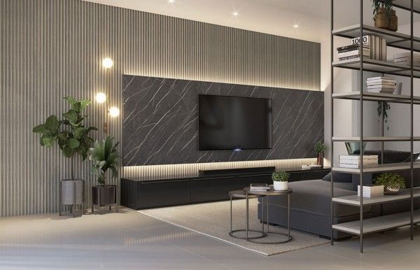 Una sala de estar con un sofá y un televisor en la pared.