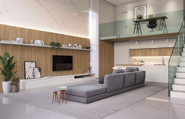 Una sala de estar con sofá, televisión y escaleras.