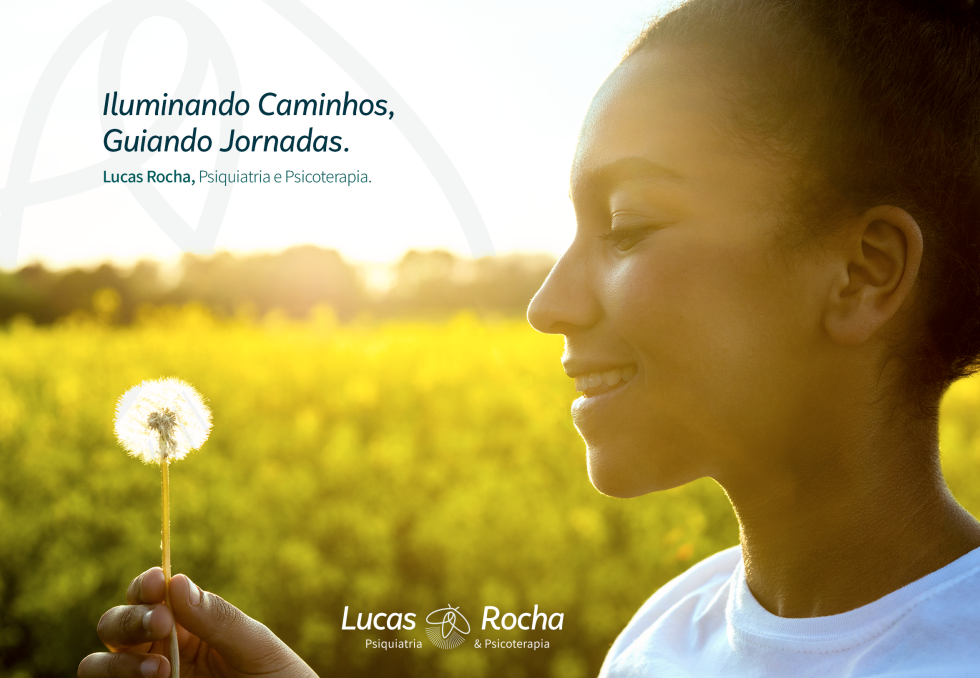 Uma mulher está segurando um dente-de-leão em frente a um campo de flores amarelas.