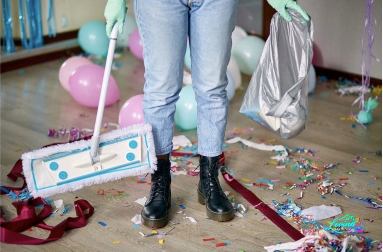 A person is standing on a messy floor holding a mop.