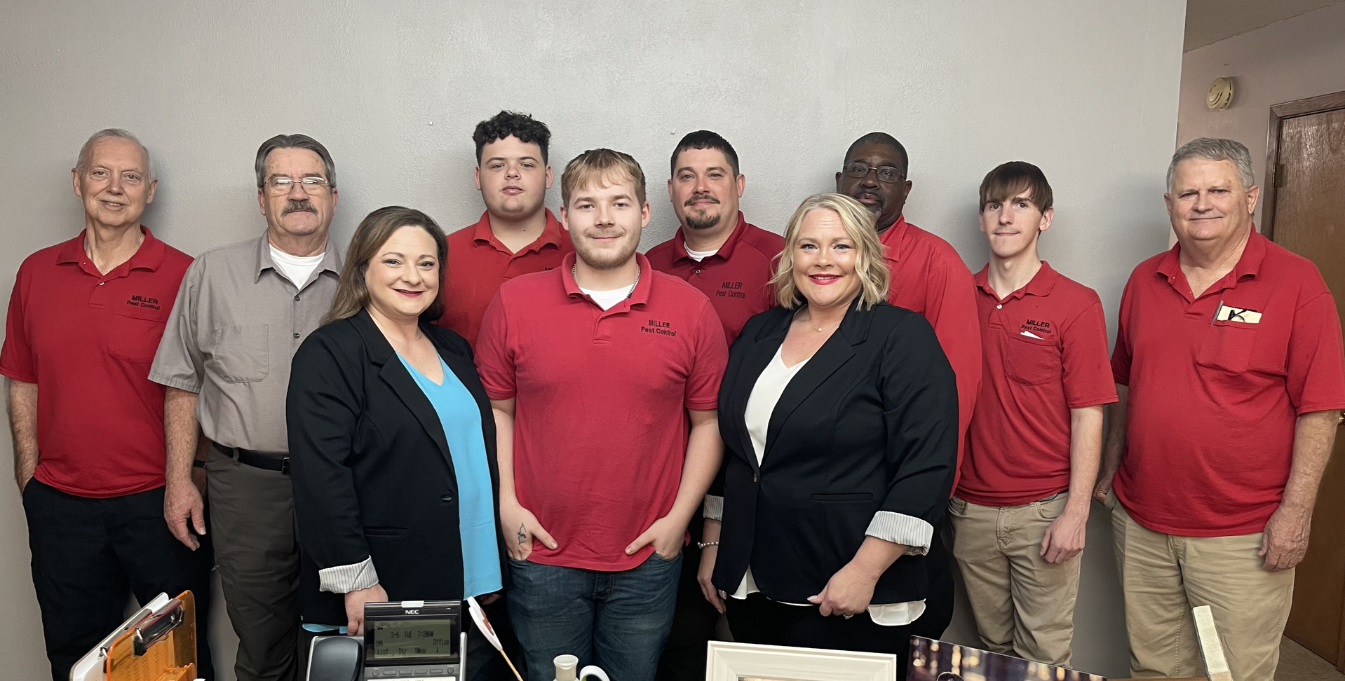 A group of people in red shirts are posing for a picture.