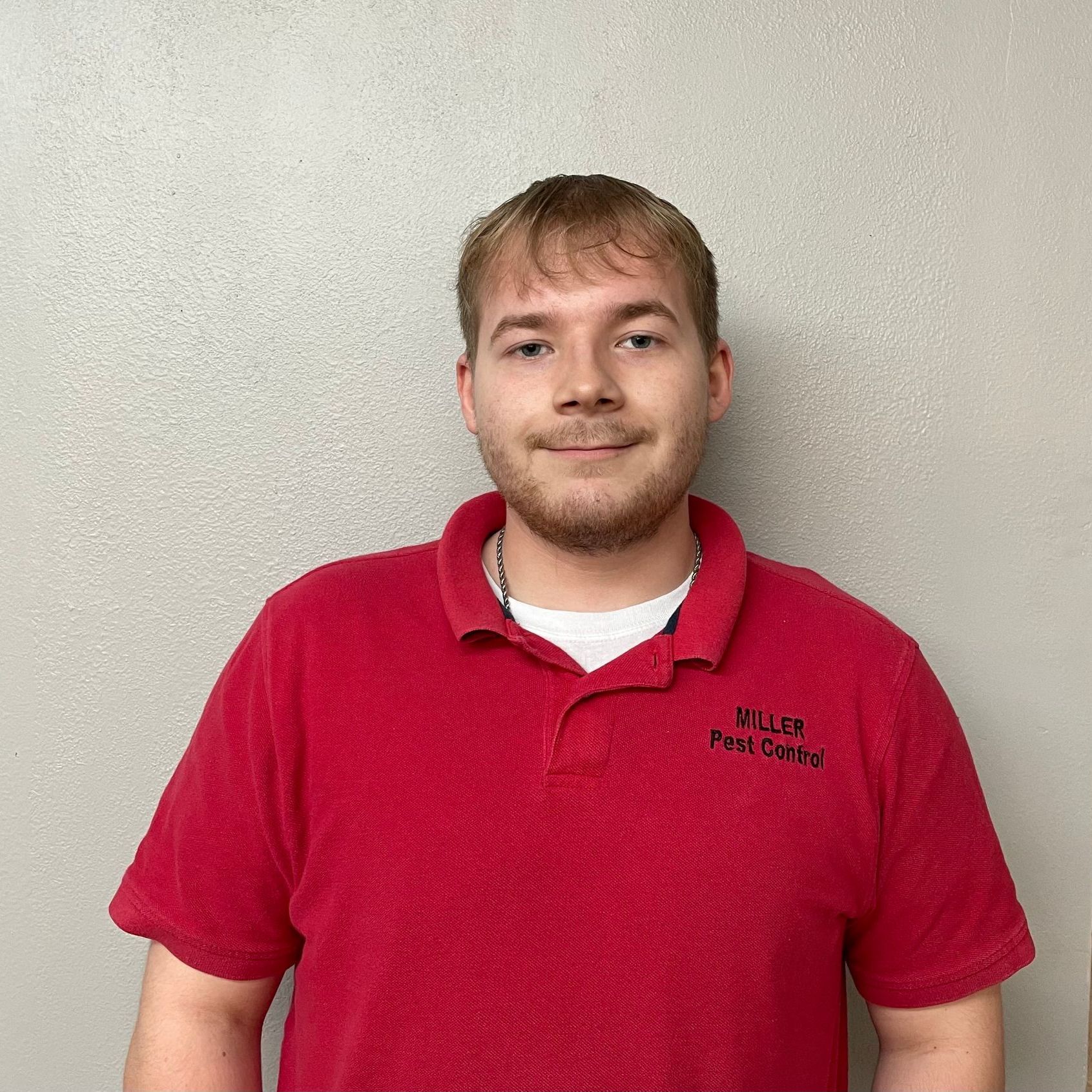 A man wearing a red shirt with the word miller on it