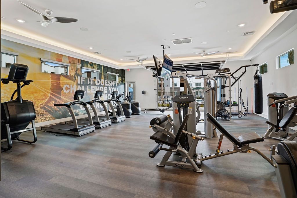 Indoor fitness center with cardio machines and weight equipment.