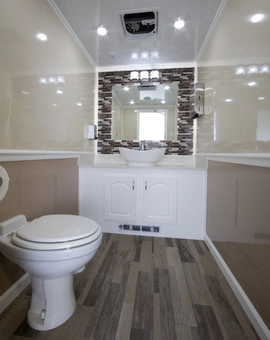 A bathroom with a toilet a sink and a mirror