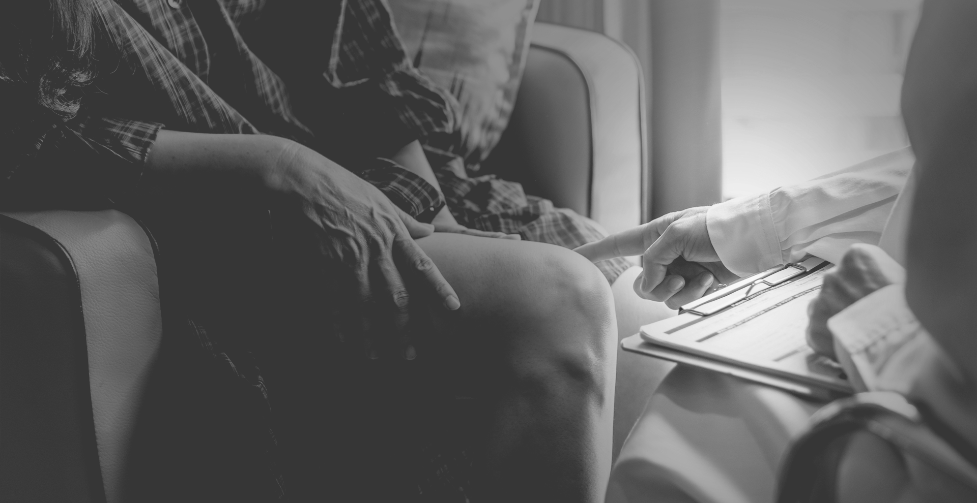 A person is sitting on a couch using a laptop computer.