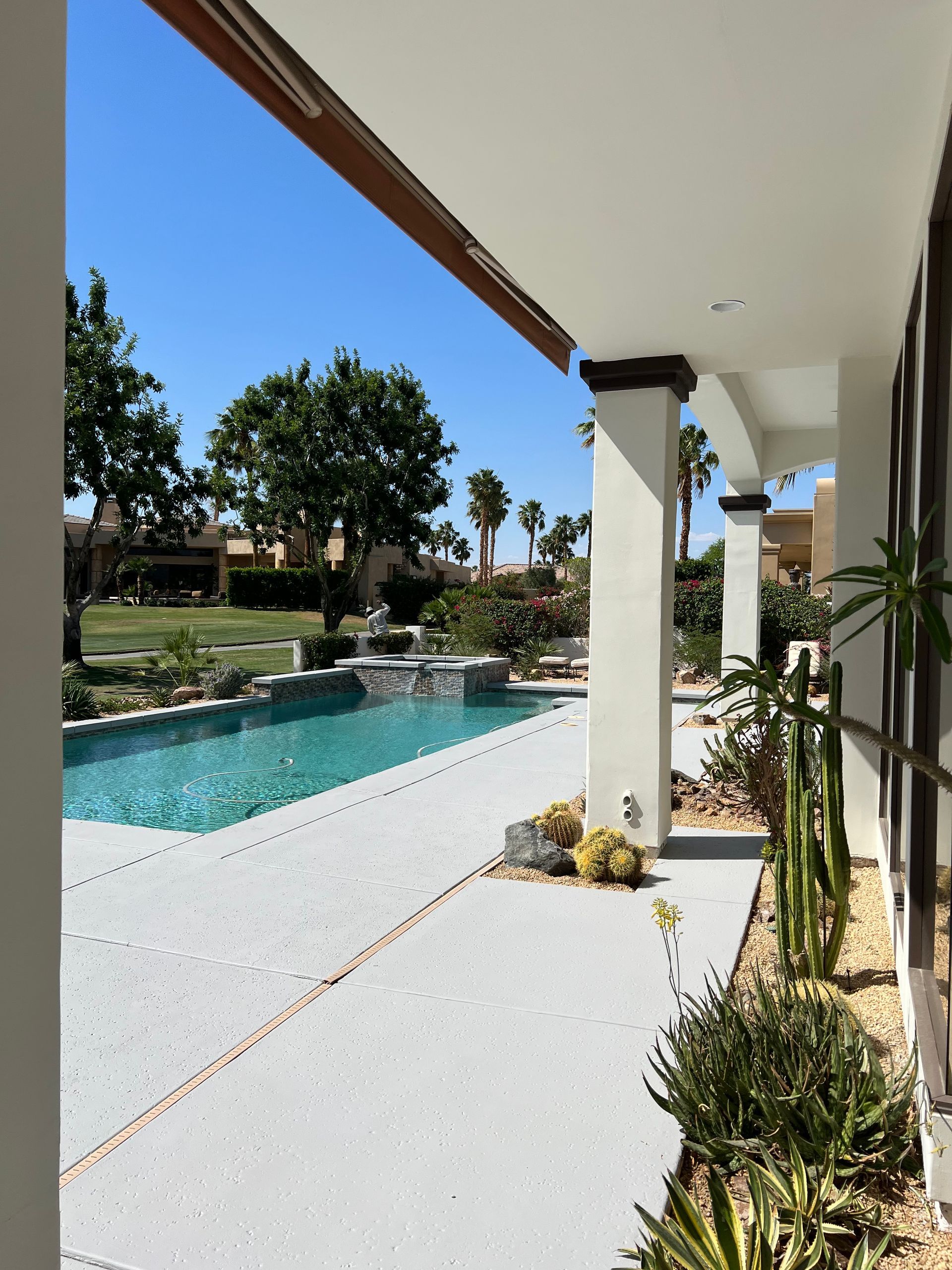 A view of a large swimming pool from a porch