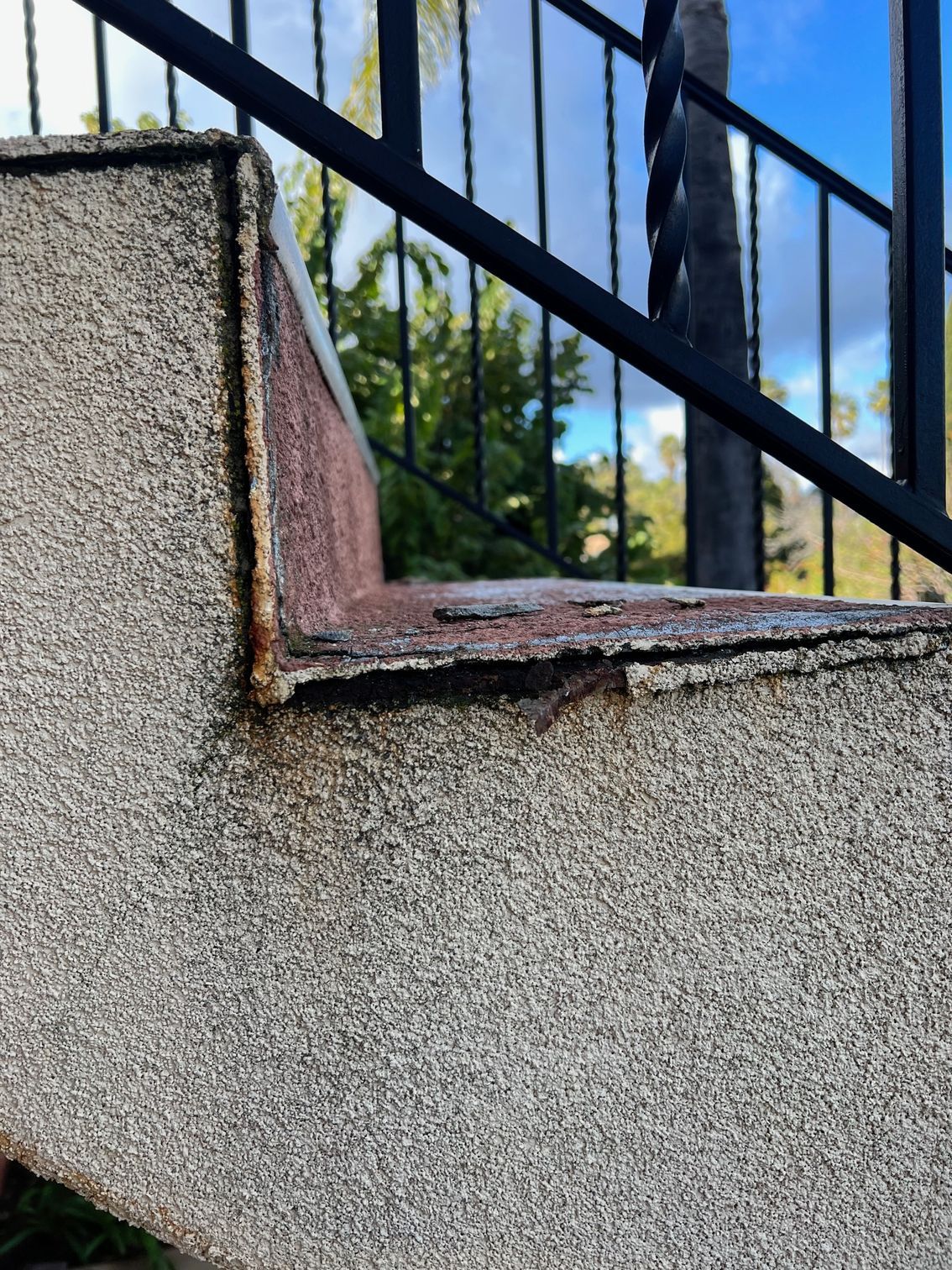 A close up of a concrete staircase with a metal railing.