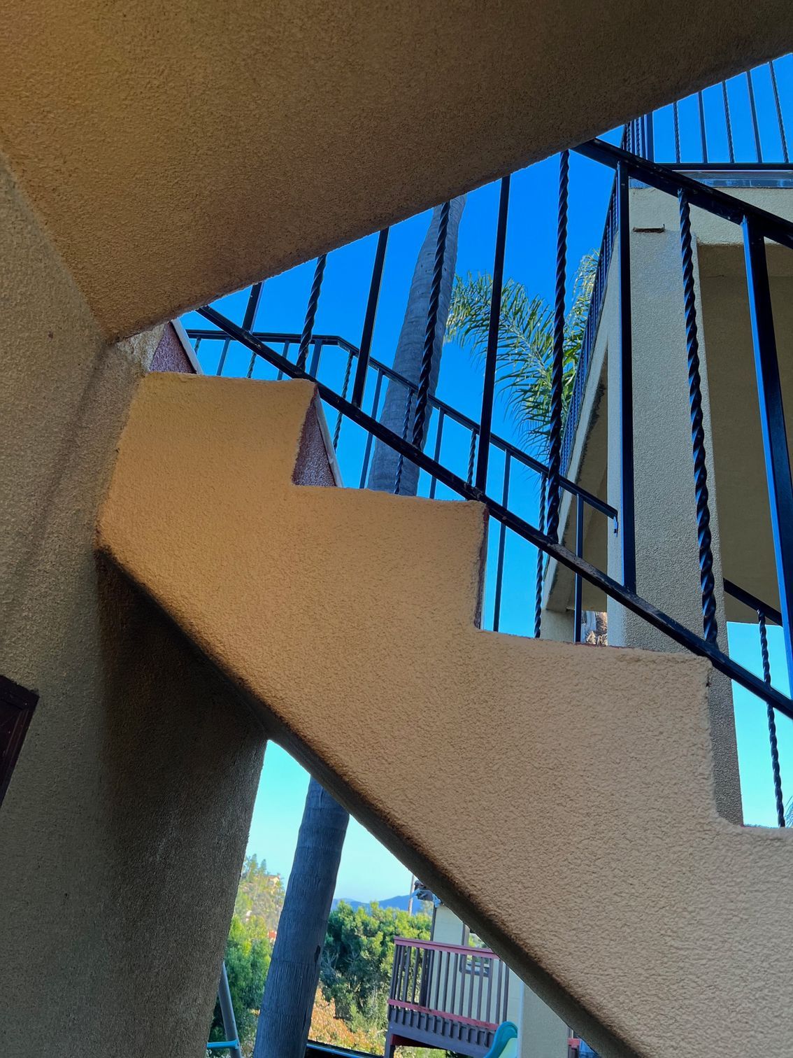Looking up a set of stairs with a blue sky in the background