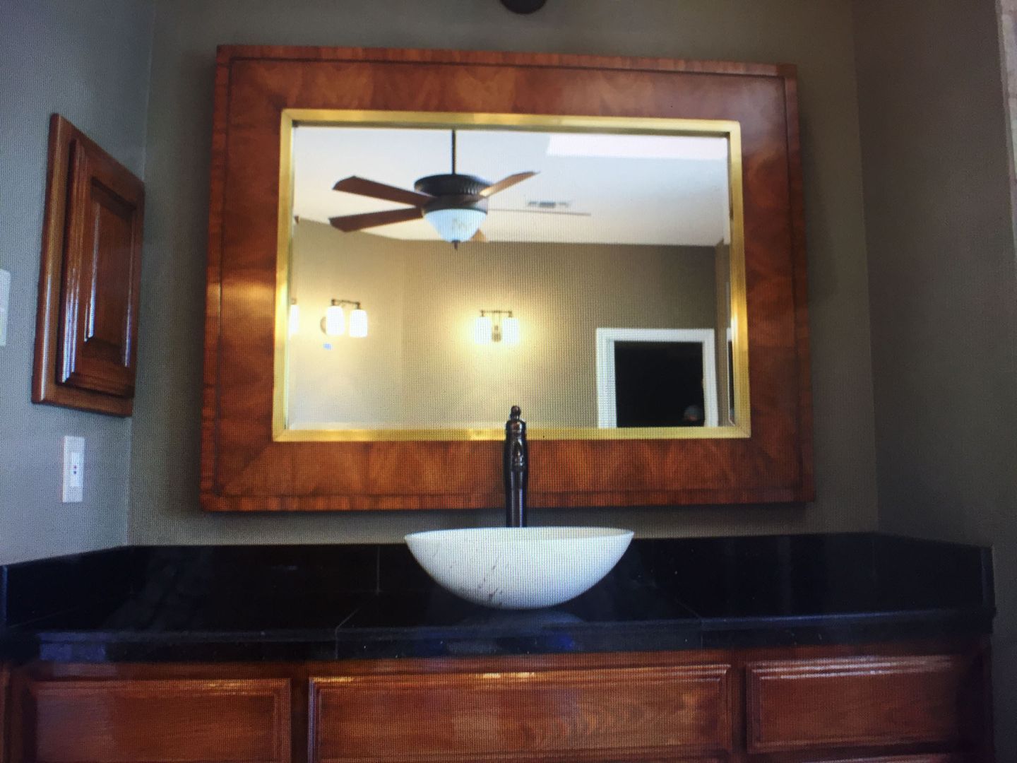 A bathroom with a sink and a large mirror