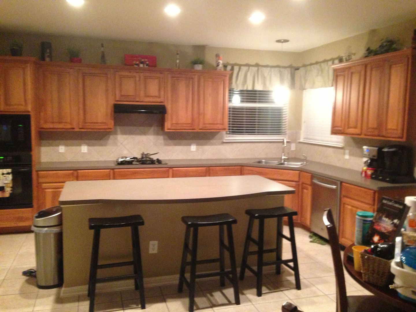 A kitchen with a large island and stools