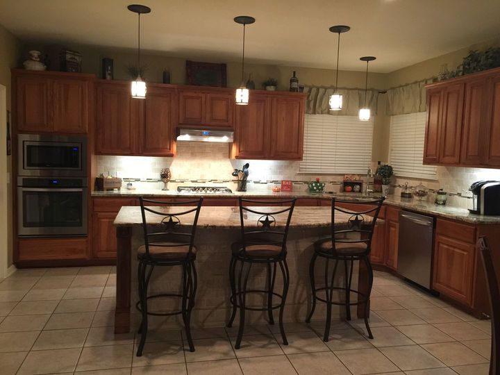 A kitchen with wooden cabinets and stainless steel appliances