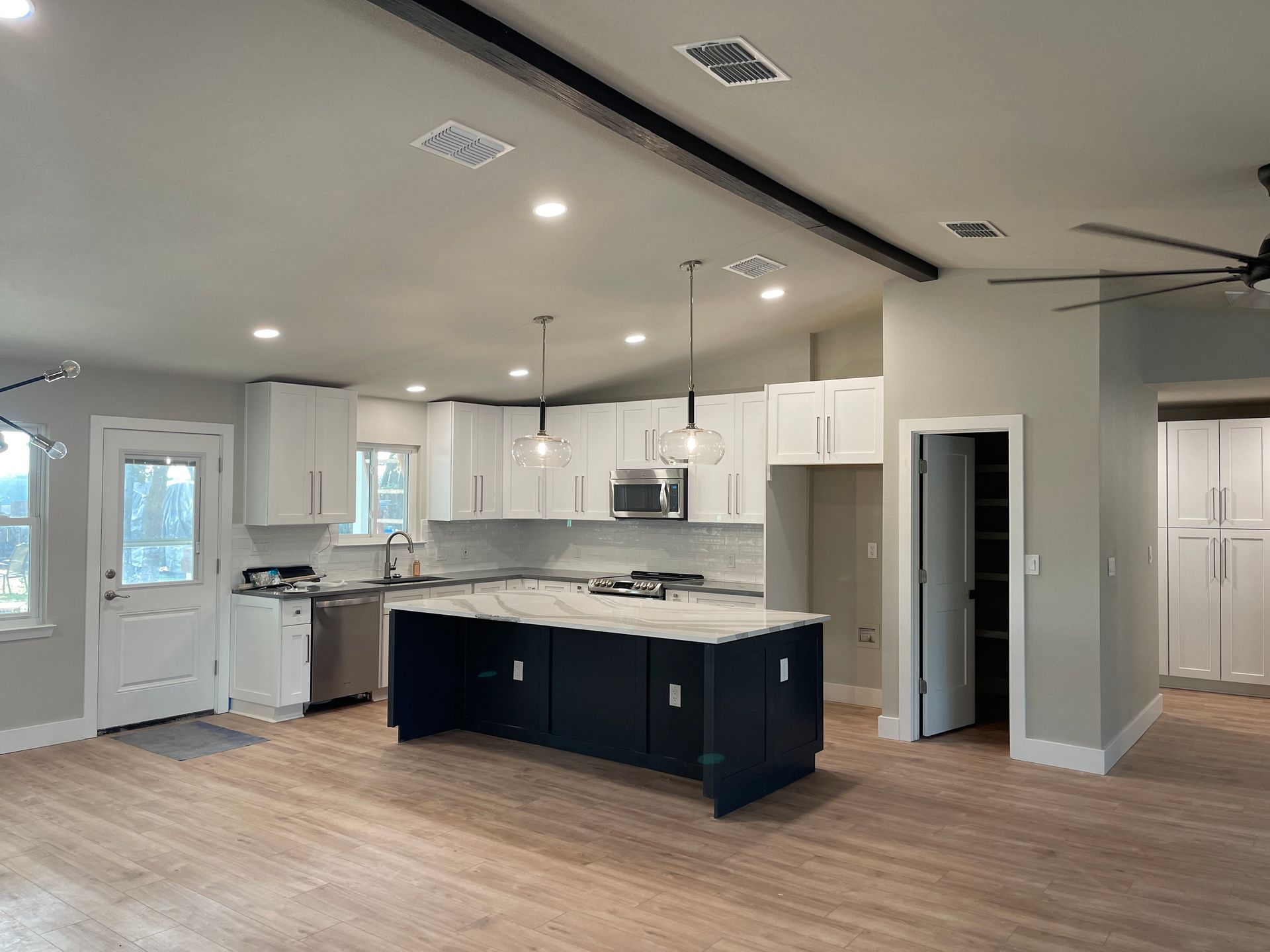 A kitchen with a large island in the middle of the room.