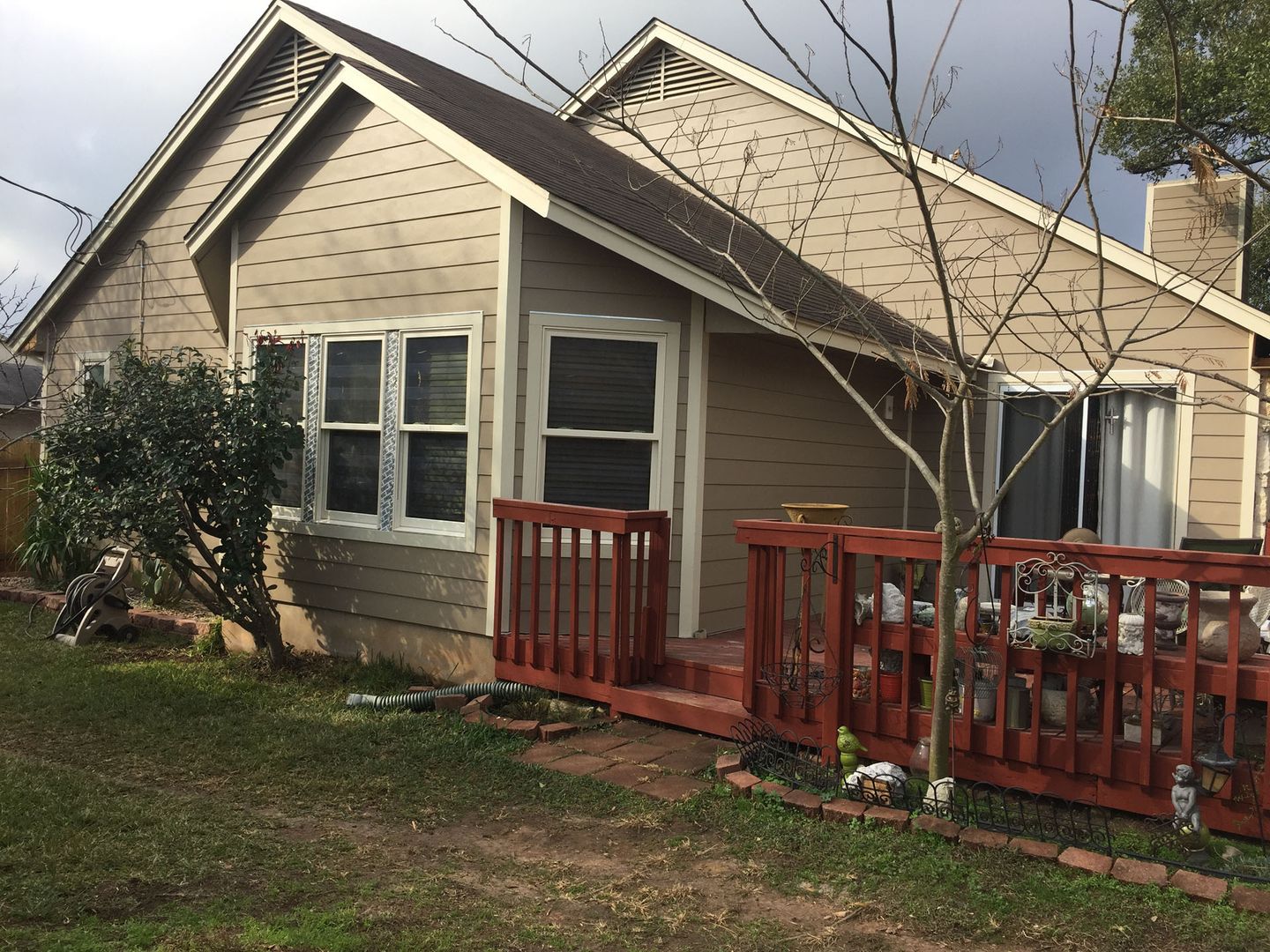 A small house with a red deck in front of it