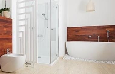 A bathroom with a bathtub , toilet , shower and bidet.