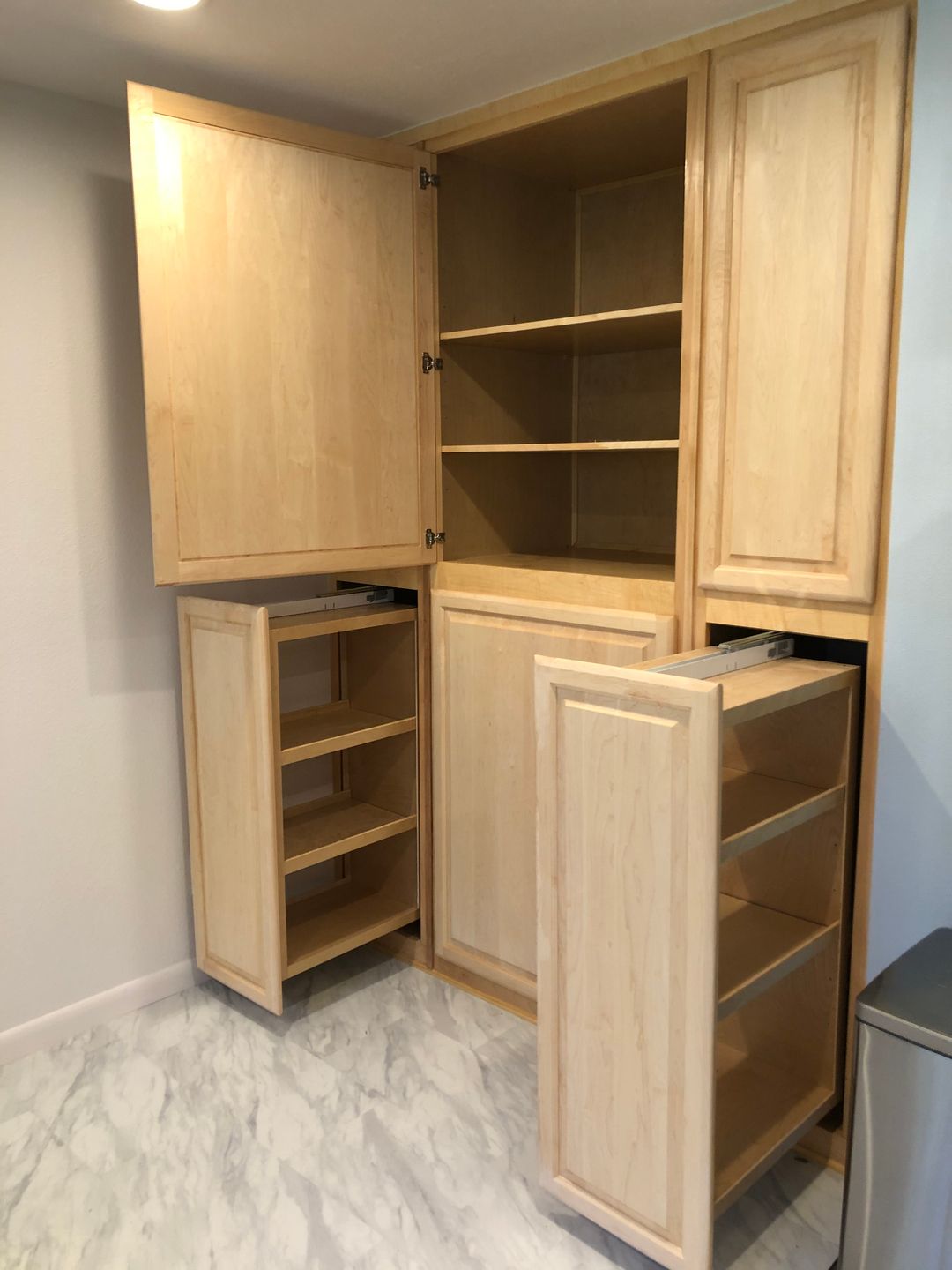 A room with a lot of wooden cabinets and shelves