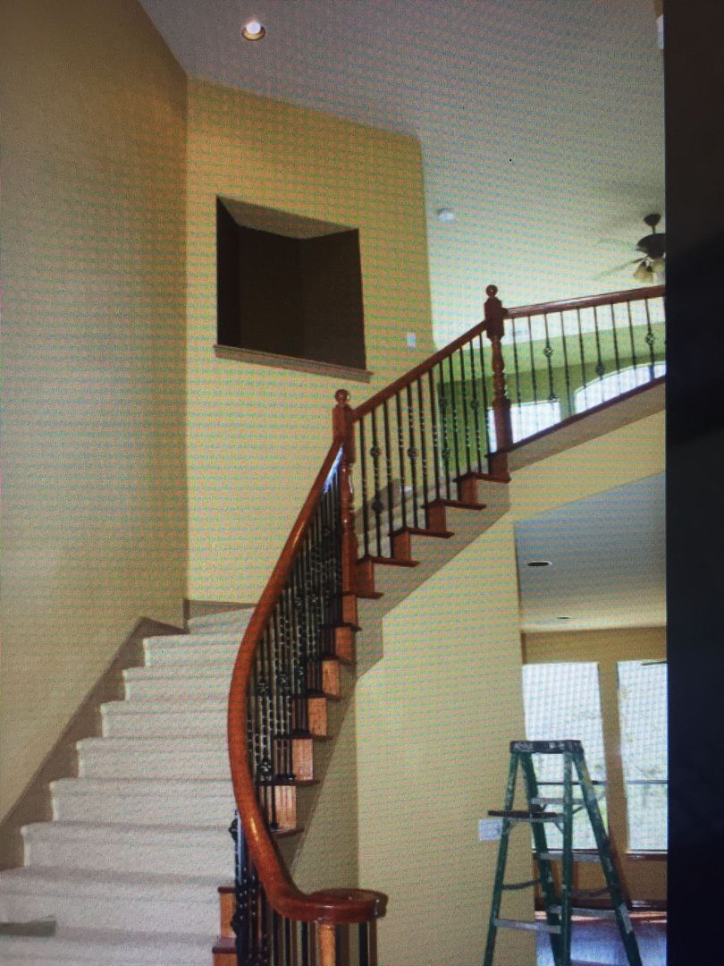 A staircase with a wooden railing in a house