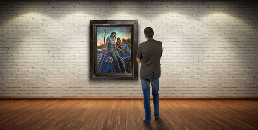 A person stands in a gallery, facing a framed painting of two figures sitting on the hood of a blue car at sunset.