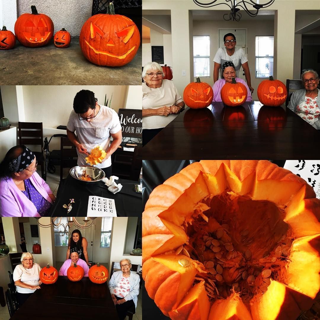 A group of people are sitting around a table with pumpkins on it