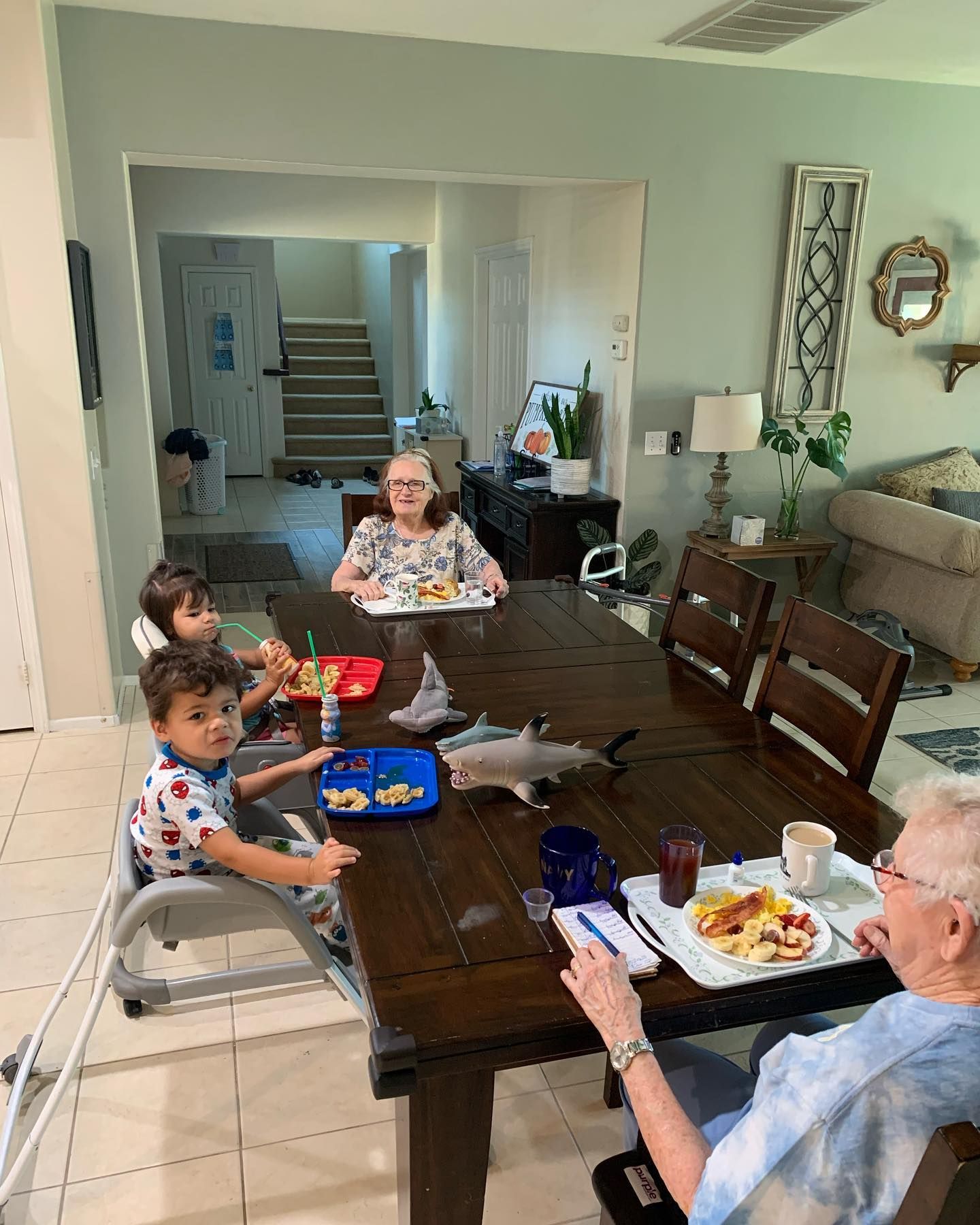 A group of people are sitting at a table eating food.