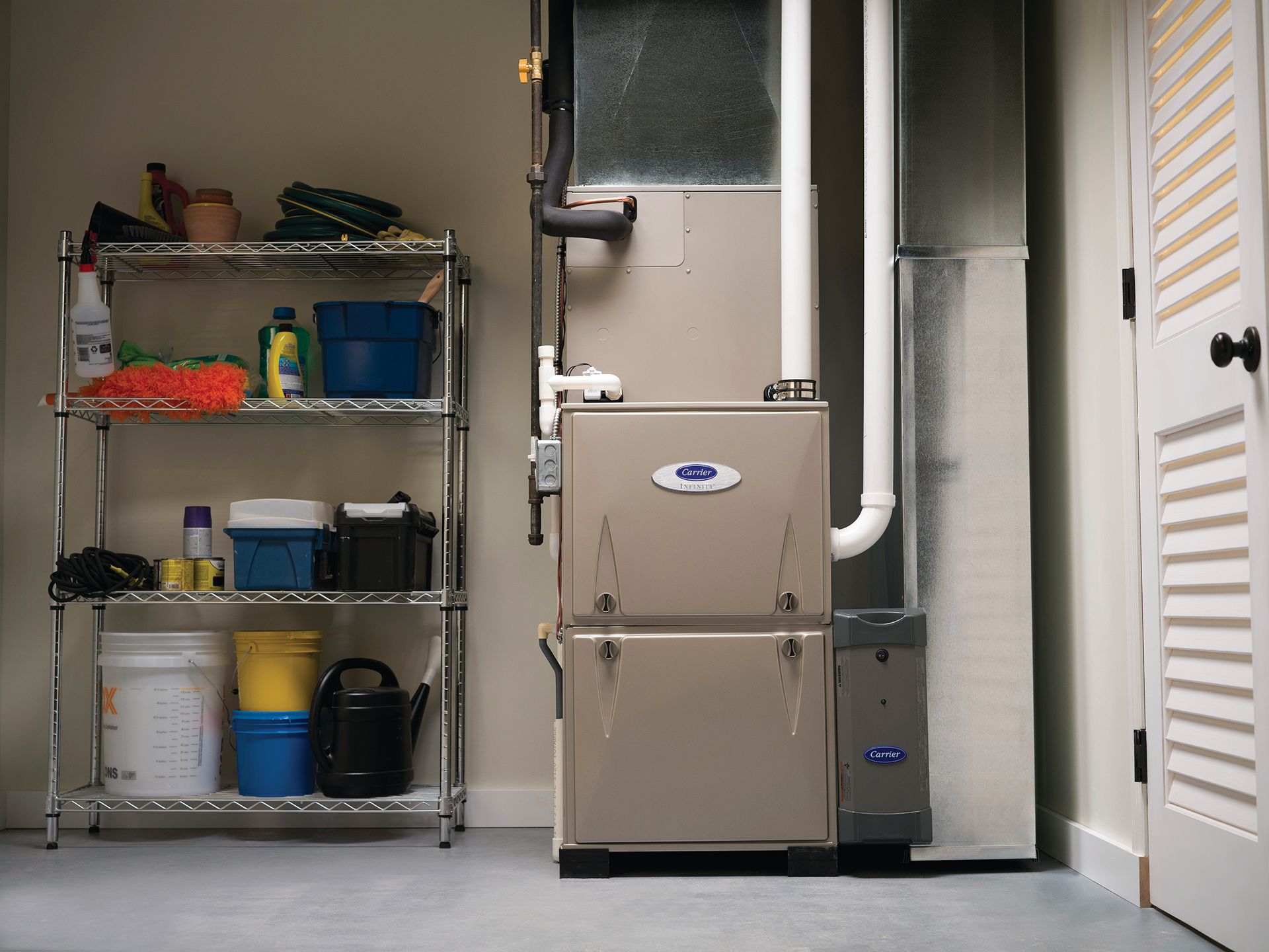 A garage with a furnace and shelves filled with cleaning supplies.