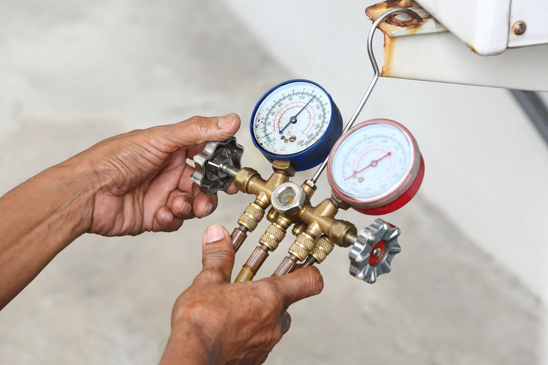 a close up of a person holding a pressure gauge .