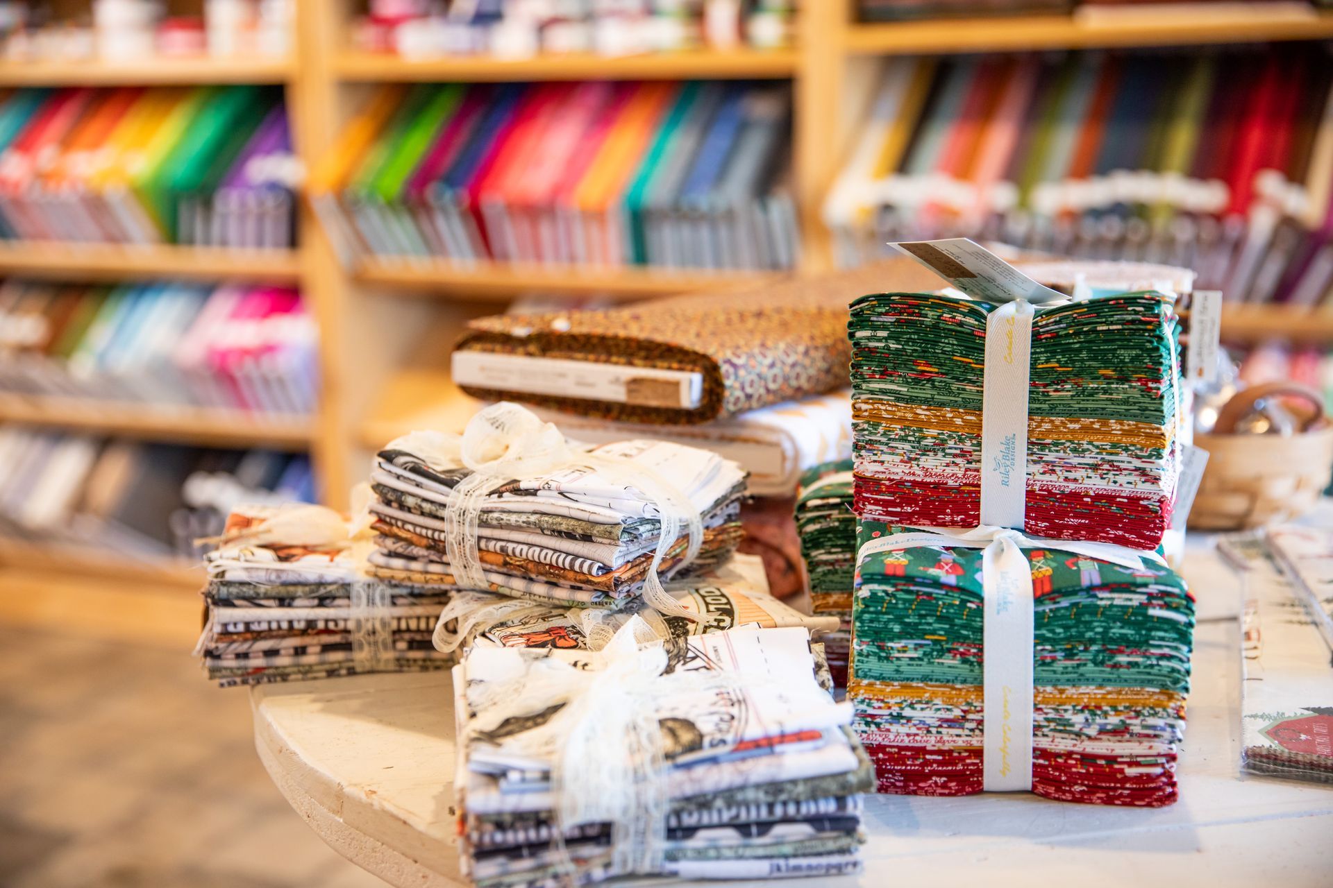A stack of fabric sitting on top of a table in a store.