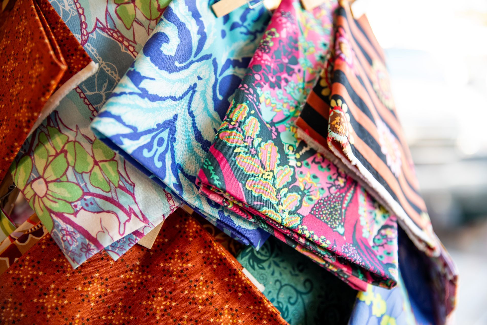 A bunch of colorful fabrics are stacked on top of each other