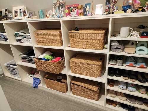 A closet filled with lots of baskets and shoes.
