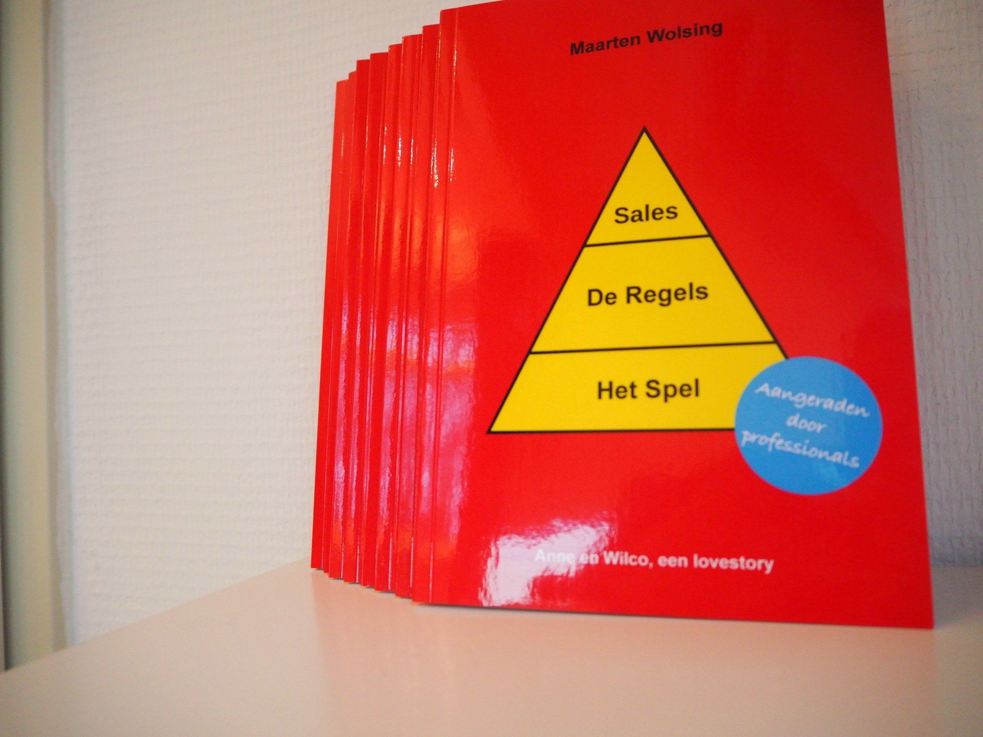 Een rood boek met een gele piramide op de omslag